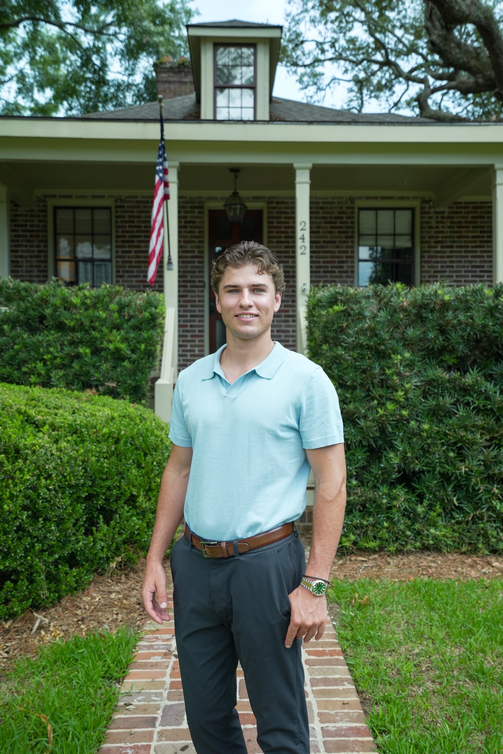 Noah Cox in front of a Charleston home